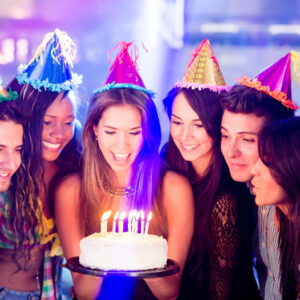 Group of people in a birthday party about to blow the candle